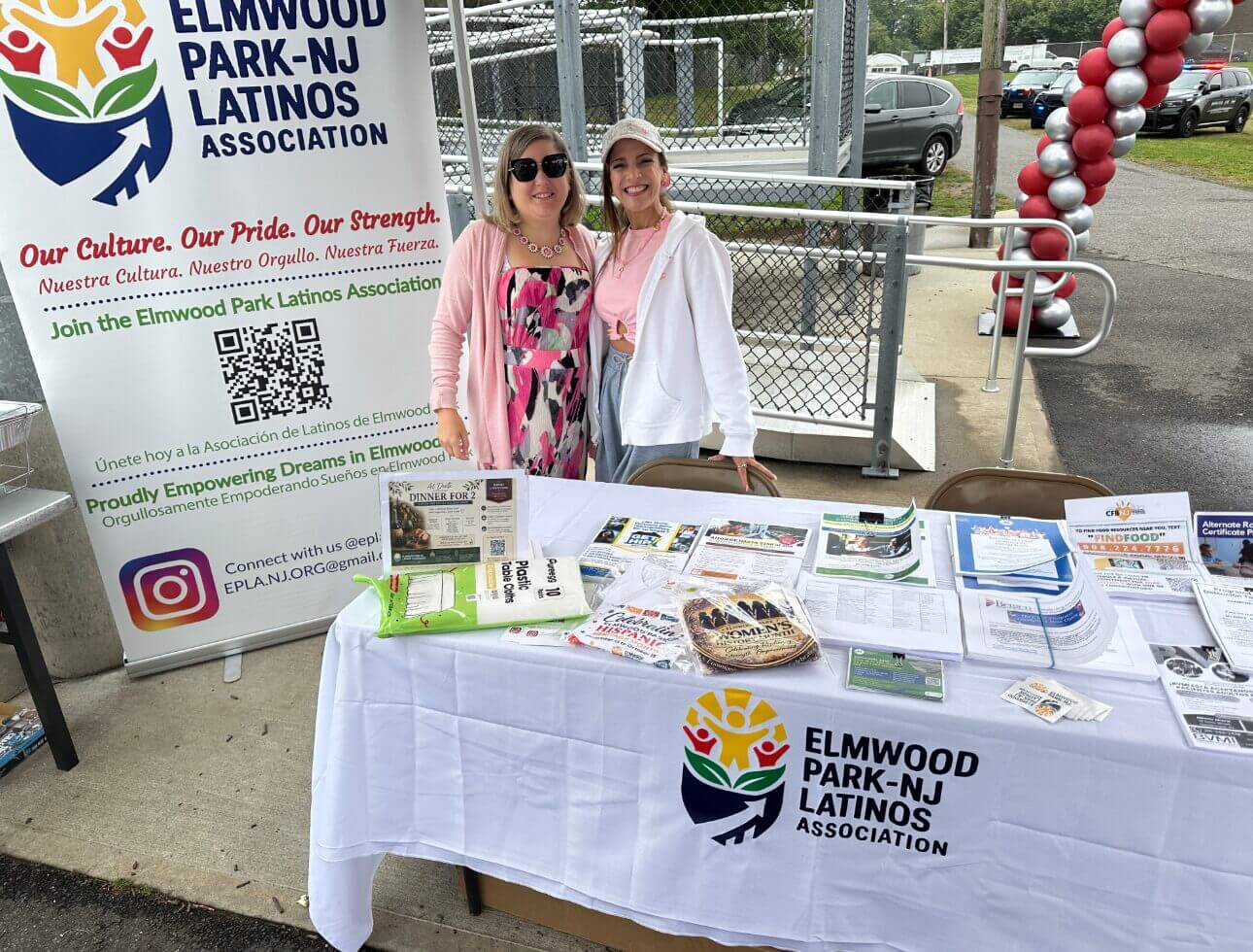 Community association table with flyers at an outdoor event